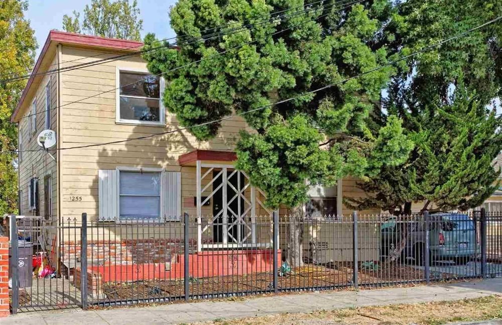 Elmhurst fourplex behind a fence